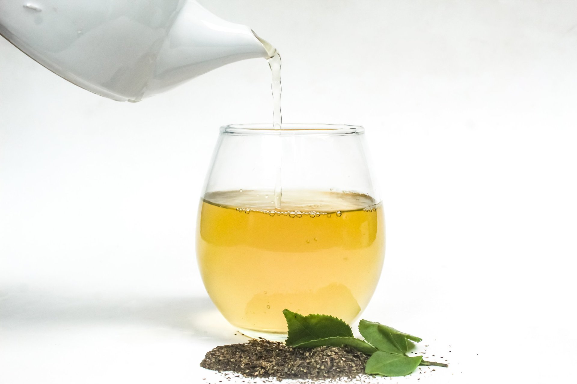 Teapot pouring green tea