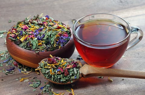 Herbal tea in wooden bowl