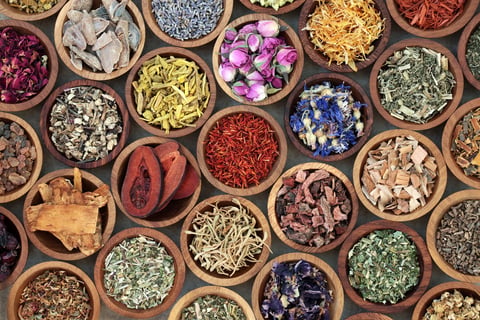 Dried herbs and flowers in wooden bowls